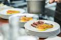 Dish with meat, corn and carrot is being prepared